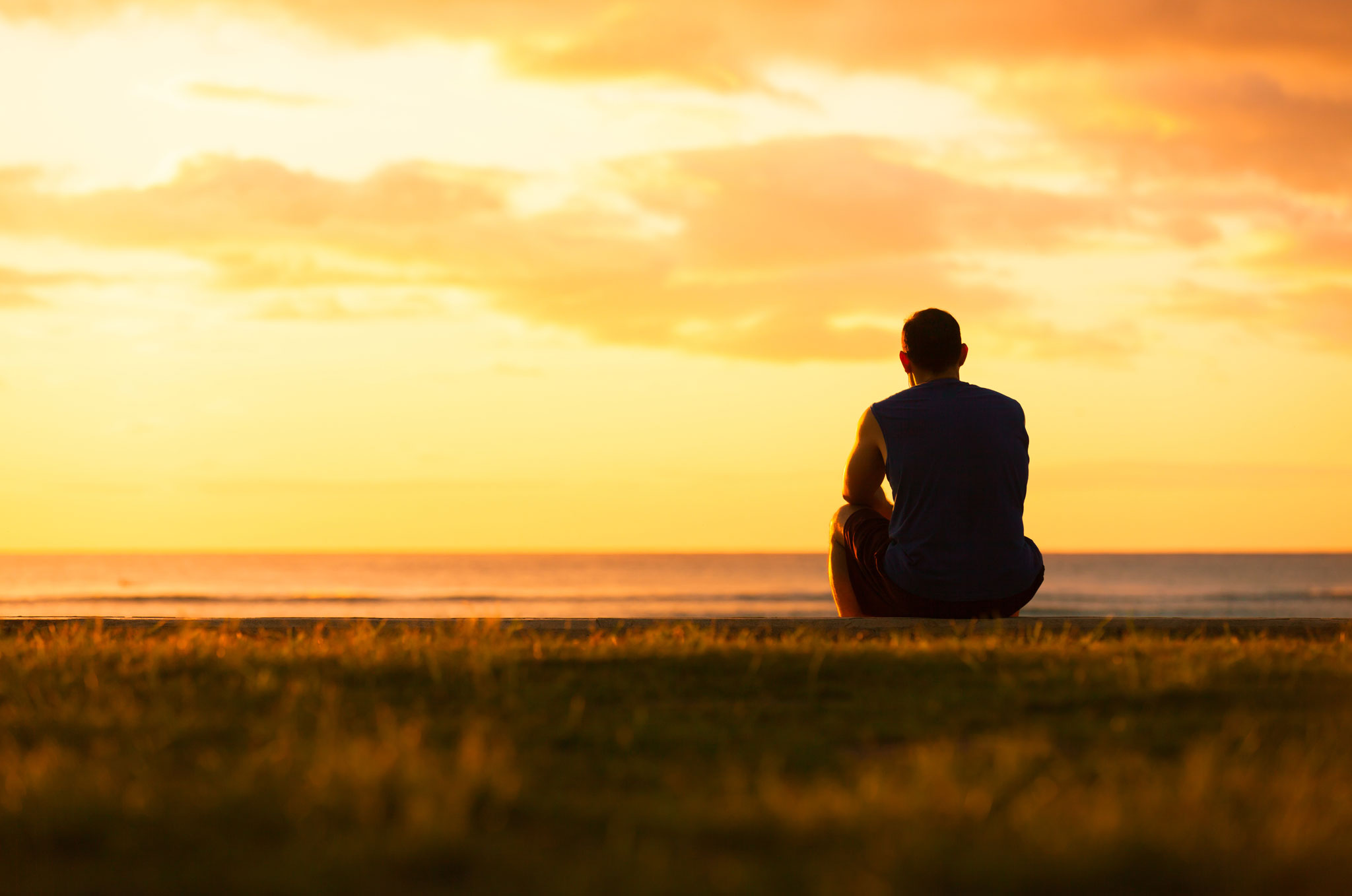 Thoughtful Man Sitting Watching The Sunset.